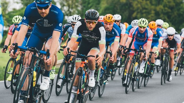 group of cyclist on asphalt road