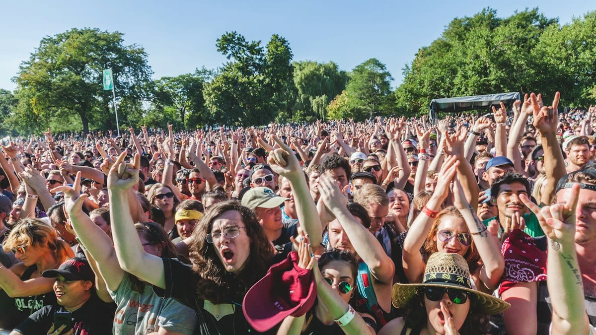group of people raising their hands during daytime