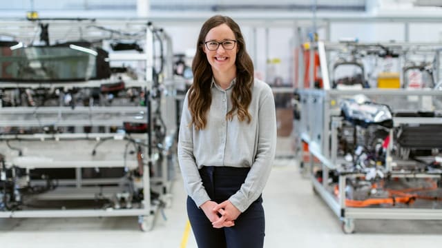 woman in white long sleeve shirt and black pants wearing black framed eyeglasses