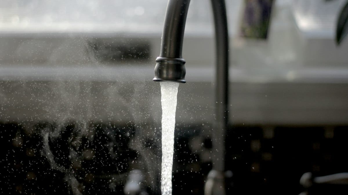 a faucet running water from a kitchen sink