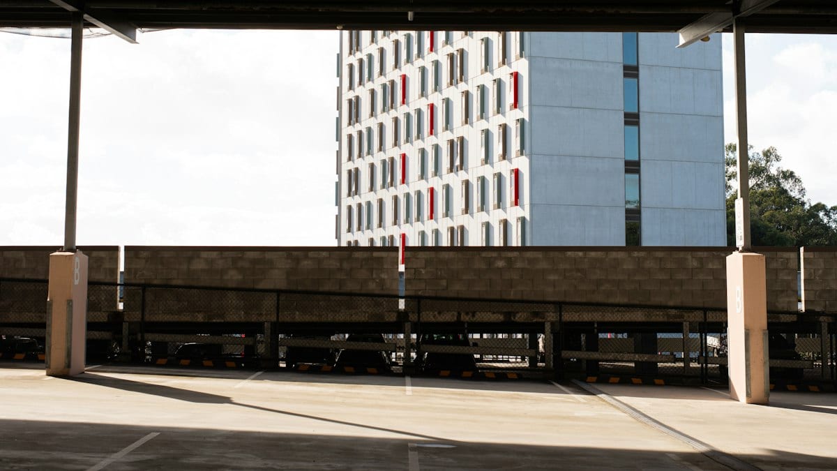 Urban parking lot overlooking a contemporary building with red windows